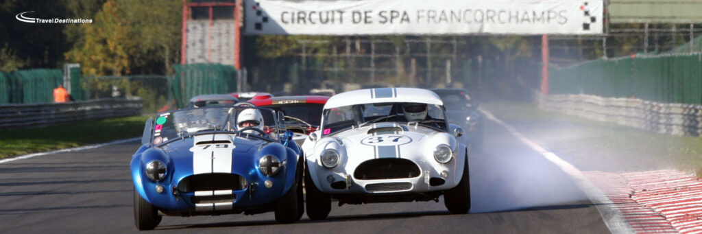 Two cars racing closely at the Spa Francorchamps circuit